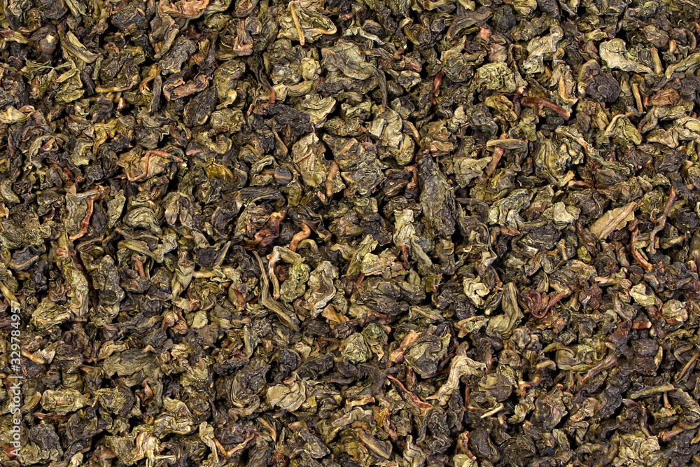 A green tea texture, background, pattern. Pile of green tea.