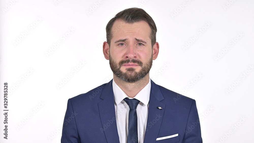Portrait of Upset Young Businessman Crying at the Camera, White Background Portrait of Upset Young Businessman Crying at the Camera, White Background