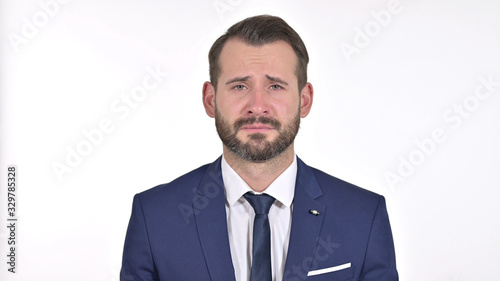 Portrait of Upset Young Businessman Crying at the Camera, White Background