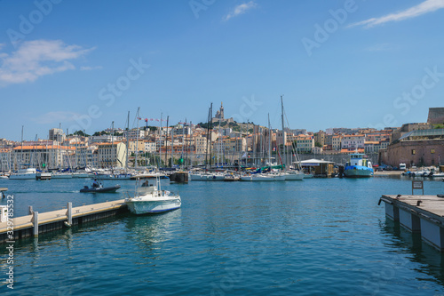 Marseille old port with yachts and the Basilique Notre-Dame de la Garde on hill