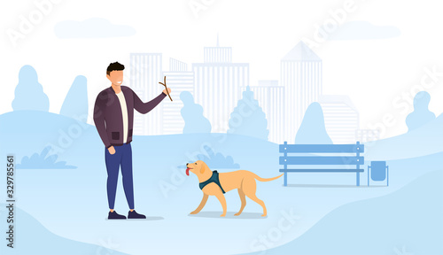 Dog owner man playing with his dog in harness in city park, throwing a twig for his happy pet