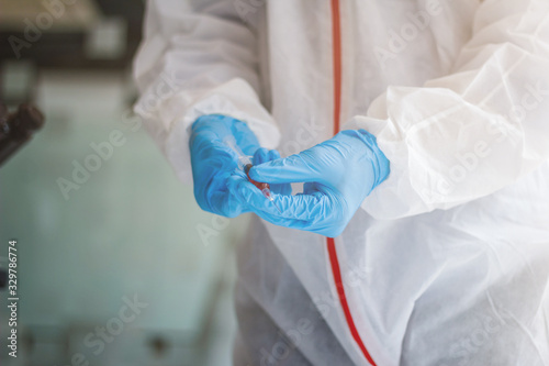 The medical team wore a coronavirus protective suit and rubber gloves to examine the coronavirus covid-19 and research for a vaccine to prevent coronavirus covid-19 to stop the epidemic.