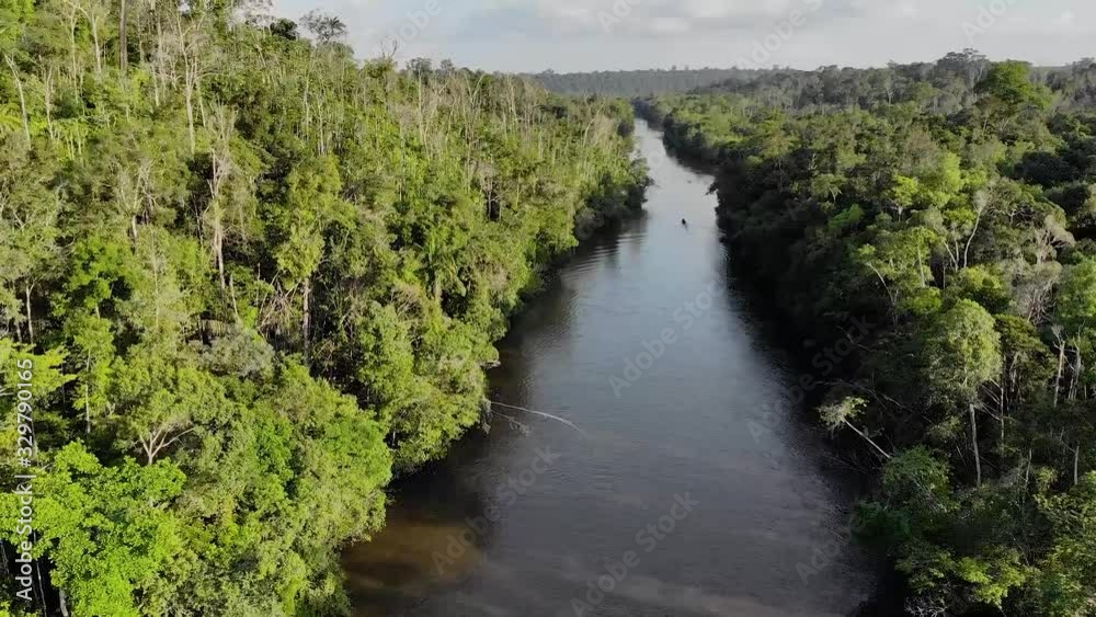Drone shot of a fisherman on a canoe on Amazon river in Brazil Drone shot of a fisherman on a canoe on Amazon river in Brazil