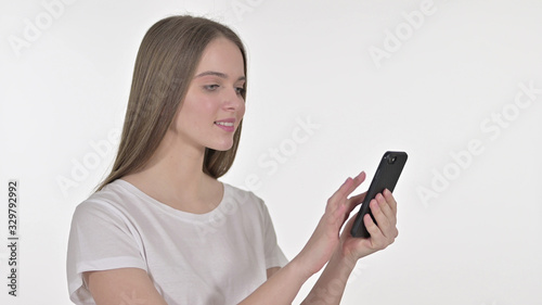 Cheerful Beautiful Woman using Smartphone, White Background © stockbakers