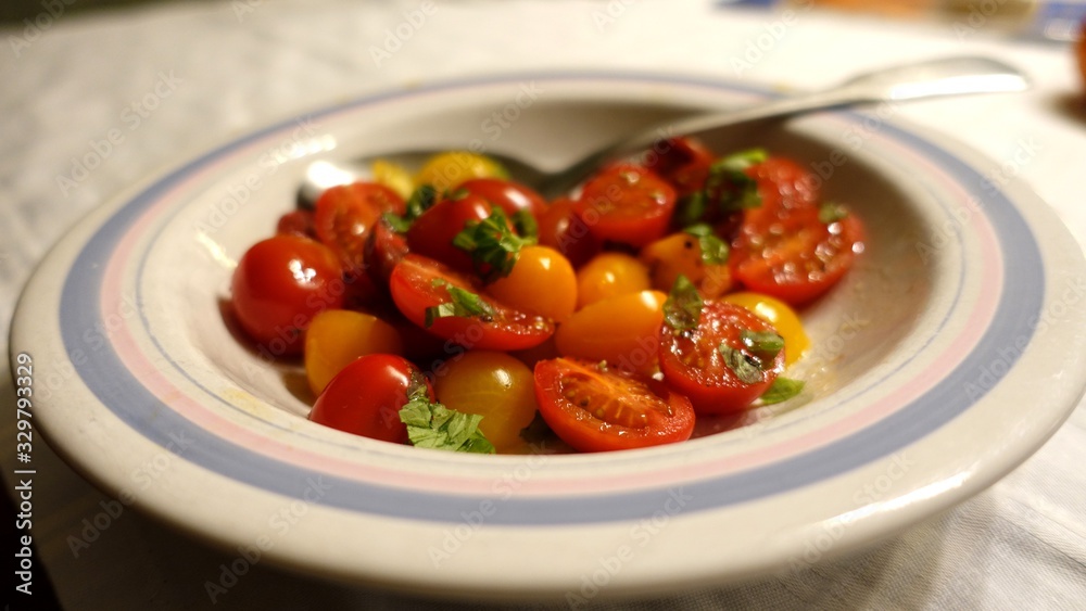 cherry tomato salad with extra virgin olive oil, salt and basil