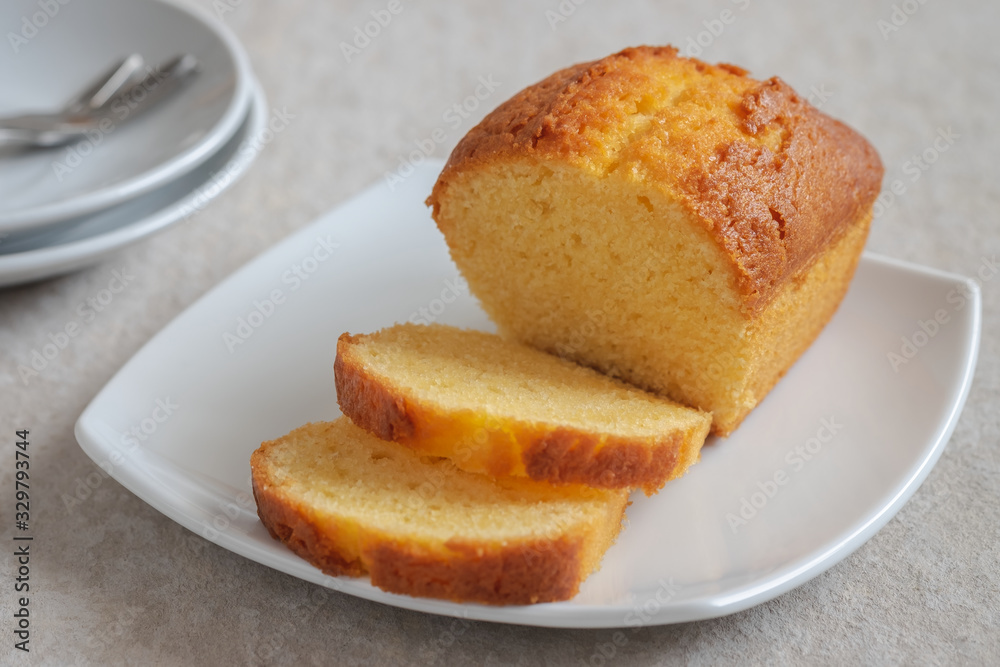 Butter cake loaf or pound cake sliced on plate.