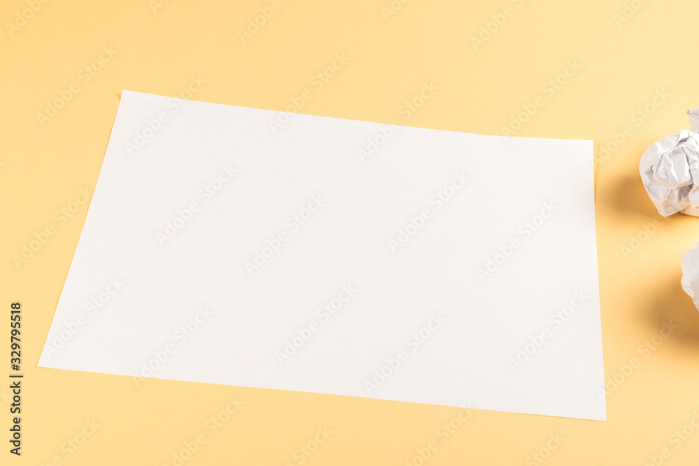 White empty sheet of paper on beige background. White empty sheet of paper on beige background.