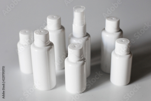 White vials and jars for medicines and tablets on a white background. Medicine. Virus. Antibiotics