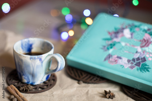 Ceramic coffee Cup, diary and lights. Romantic mood. Breakfast. Lunch