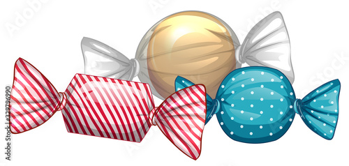 Three candies in colorful wrappers on white background