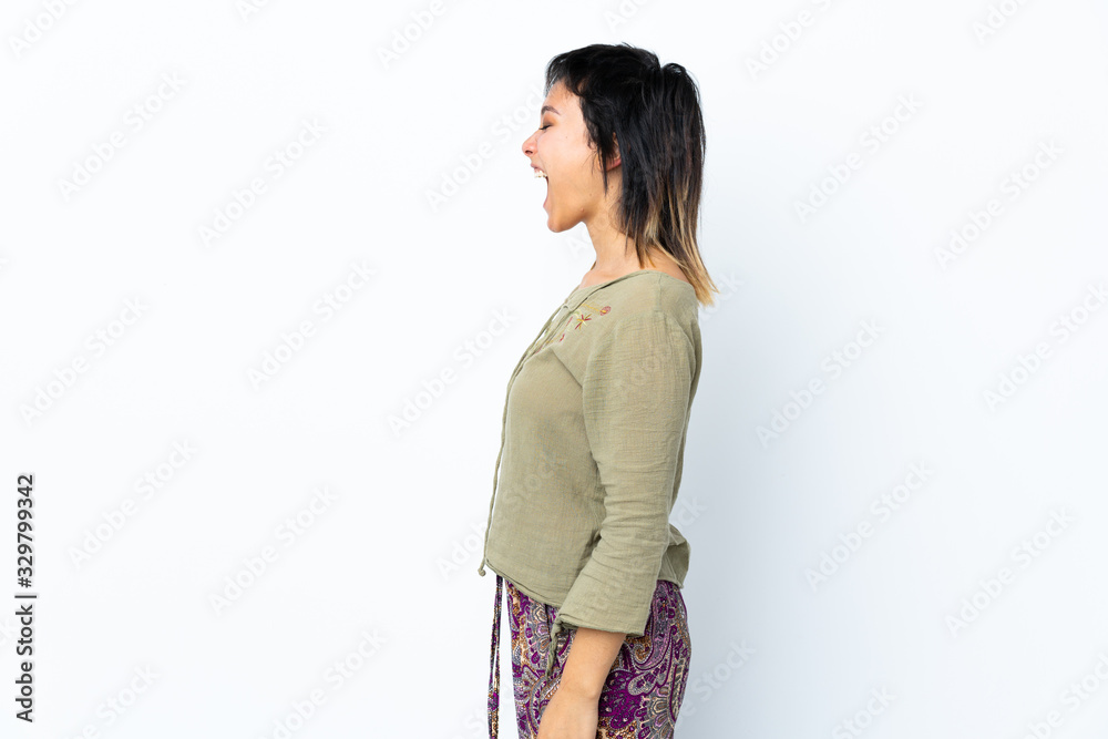 Young Uruguayan girl over isolated white background laughing in lateral position Young Uruguayan girl over isolated white background laughing in lateral position