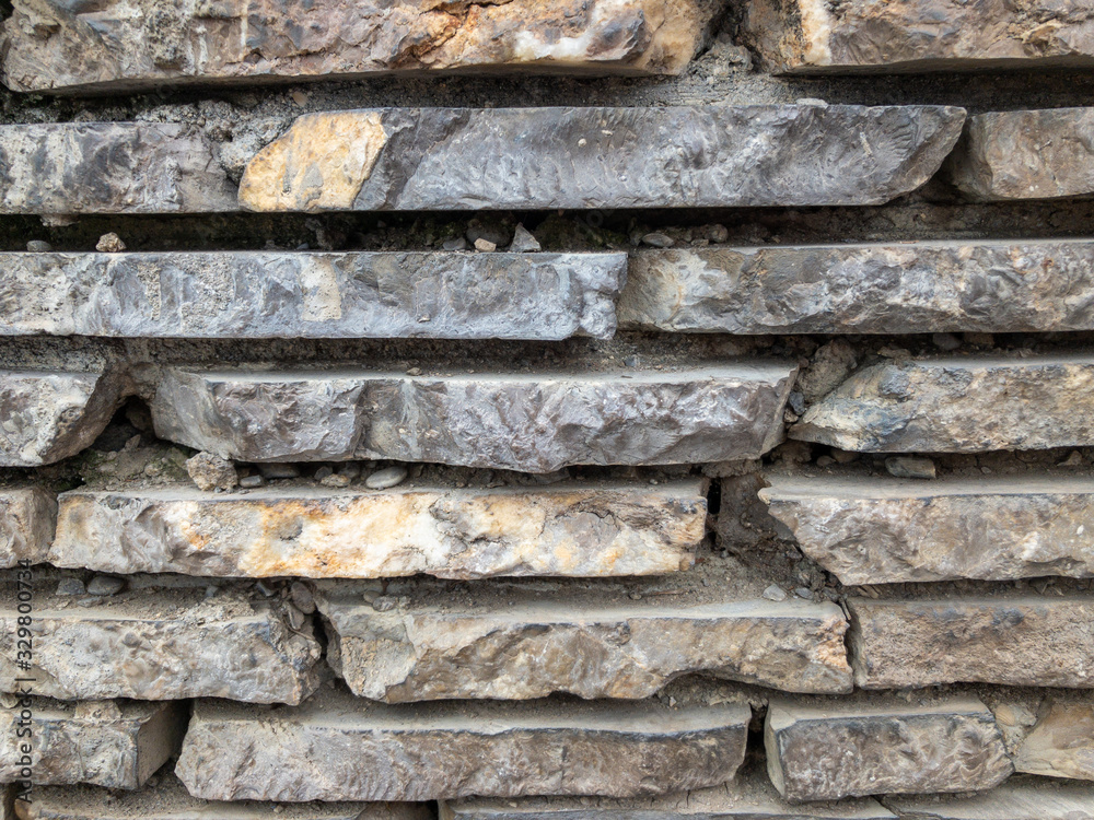 The surface of a stone wall. Masonry walls of old stone blocks. The surface of a stone wall. Masonry walls of old stone blocks.