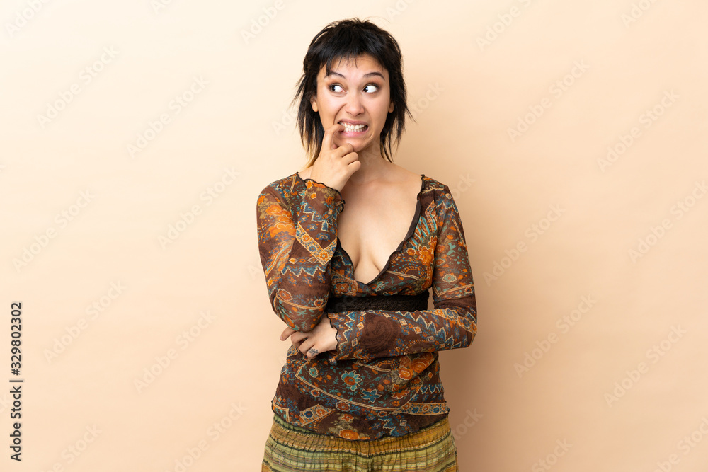 Indian woman isolated on beige background nervous and scared Indian woman isolated on beige background nervous and scared