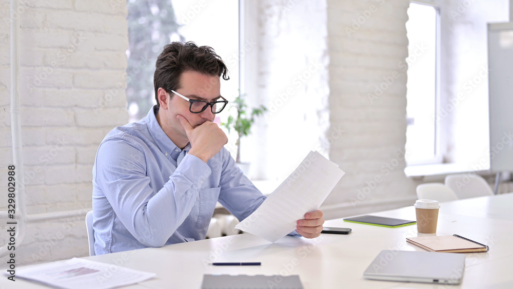 Pensive Young Man Thinking and Writing on Paper Pensive Young Man Thinking and Writing on Paper