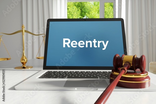 Reentry – Law, Judgment, Web. Laptop in the office with term on the screen. Hammer, Libra, Lawyer. photo