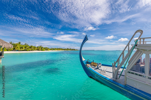 Inspirational Maldives beach design. Maldives traditional boat Dhoni and perfect blue sea with lagoon. Luxury tropical paradise concept. Exotic travel landscape, seascape in Maldives © icemanphotos