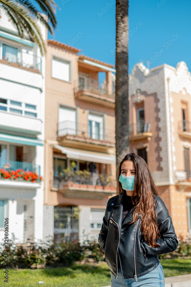 Girl with a mask to protect walking on the street