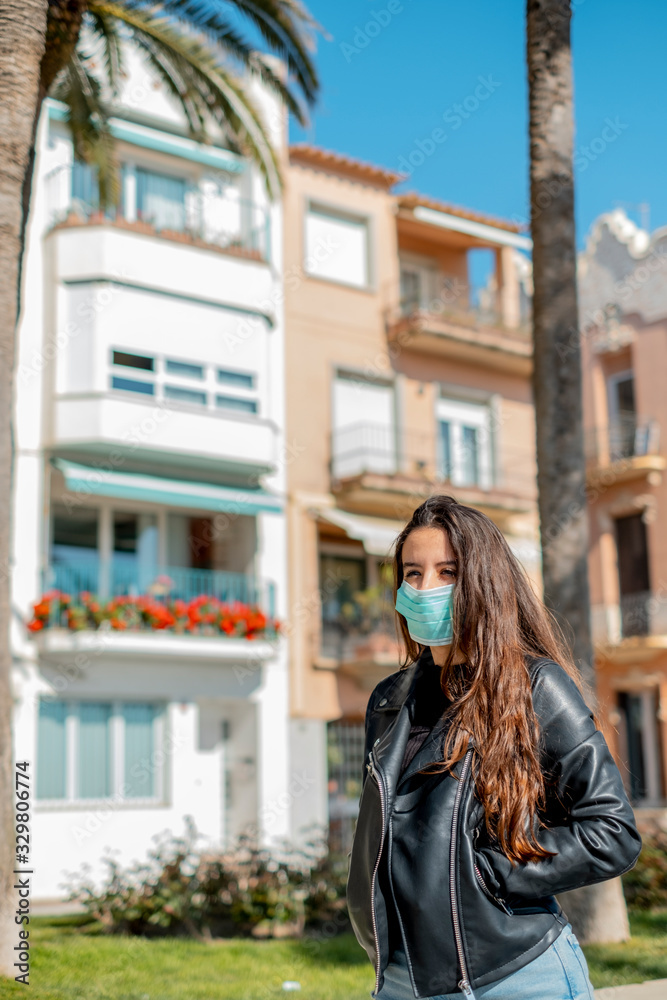 Girl with a mask to protect walking on the street