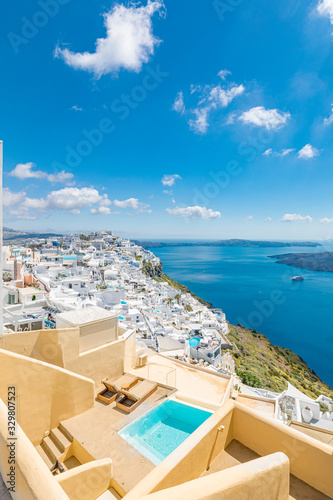 Santorini, Greece. Famous view of traditional white architecture Santorini landscape with blur sea in foreground. Summer vacations background. Luxury travel tourism concept. Amazing summer destination