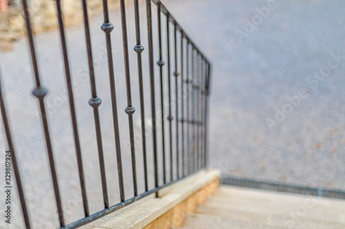 Iron railing and doorsteps, classic handrail and side panel design at house entrance in sunset