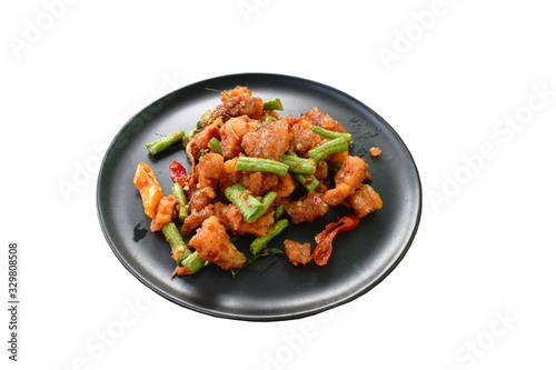spicy stir fried crispy pork crackling with chili and ginger on plate