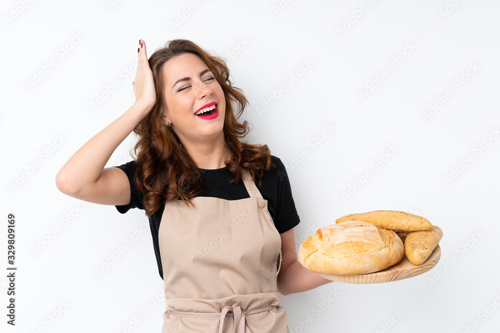 Woman in chef uniform. Female baker holding a table with several breads has realized something and intending the solution Woman in chef uniform. Female baker holding a table with several breads has realized something and intending the solution