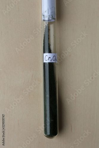Fotografie Green trivalent chromium oxide in a test tube, a very refractory crystalline substance, is used as a pigment for the production of green glass