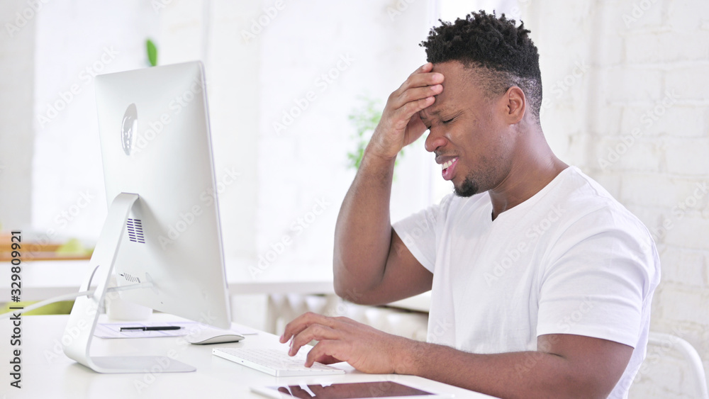 Tired Casual African Man having Headache in Office