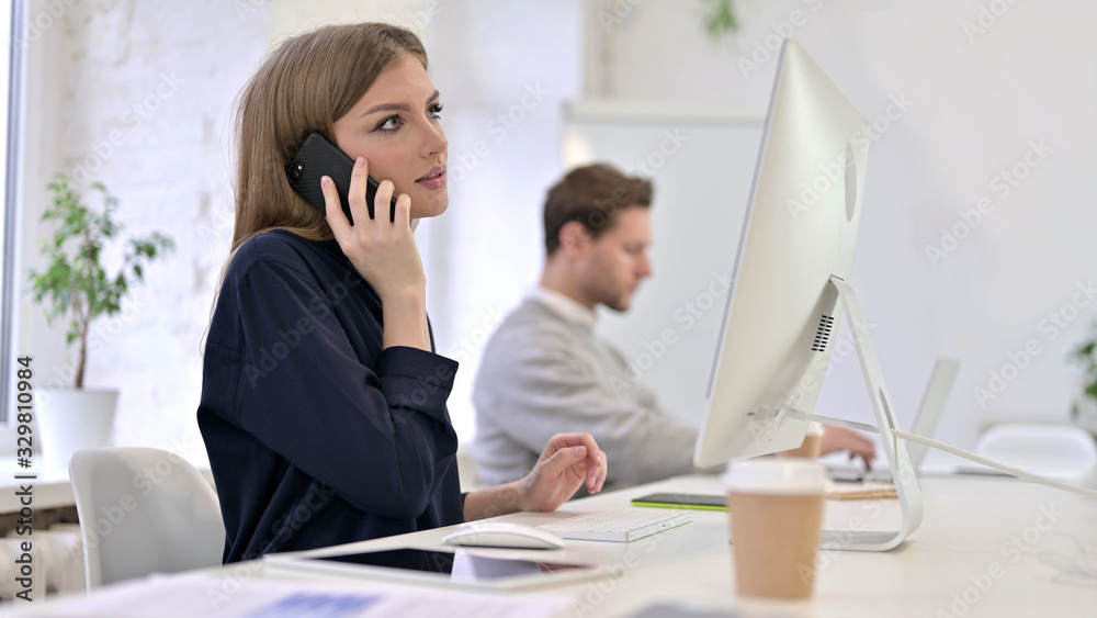 Happy Creative Woman Talking on Smart Phone in Office Happy Creative Woman Talking on Smart Phone in Office