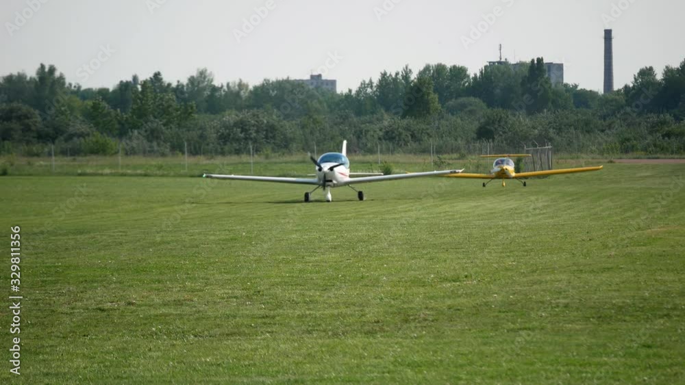 Ultralight small private aircraft airplanes moving on the airfield. Aviation festival holiday at the aerodrome airport Ultralight small private aircraft airplanes moving on the airfield. Aviation festival holiday at the aerodrome airport