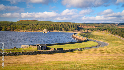 Kielder Dam on a sunny day, at Kielder Water and Forest Park in Northumberland, which has the largest man made lake in Northern Europe. The reservoir sits in the North Tyne Valley photo