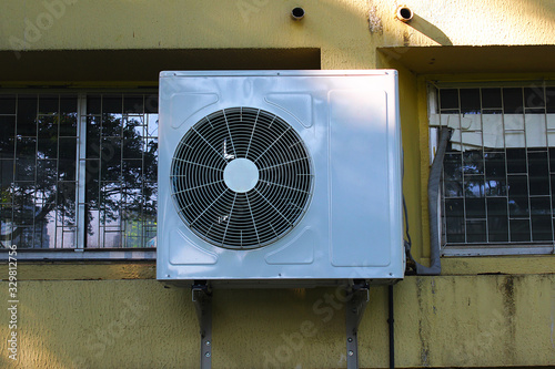 A compressor of air conditioner placed on the wal