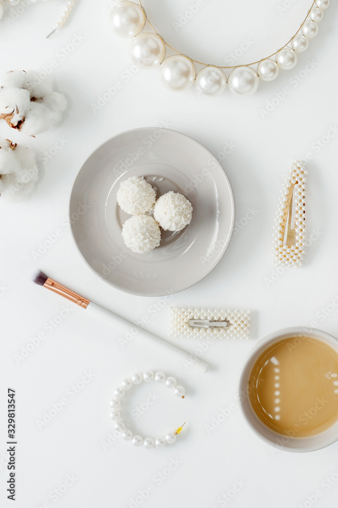 Fototapeta premium Wedding background, decorated with decorations for the bride's dress, white feather, cotton flower, pearl hairpins, around the text space, all in pastel colors. Concept preparation for the wedding