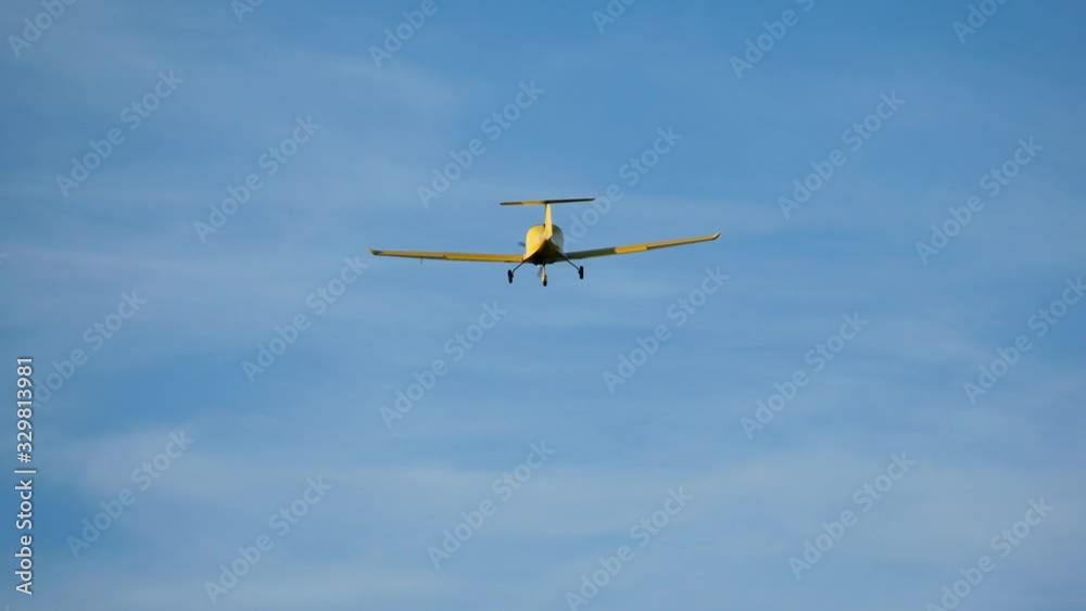 Ultralight small yellow aircraft airplane flying in the sky over the airfield. Aviation festival holiday at the aerodrome Ultralight small yellow aircraft airplane flying in the sky over the airfield. Aviation festival holiday at the aerodrome