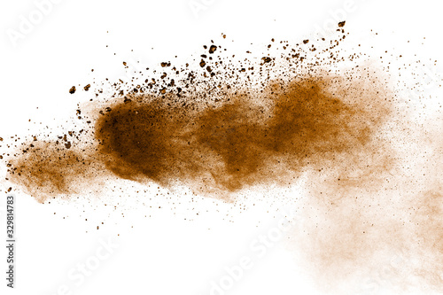 Brown powder dust cloud.Brown particles splattered on white background.