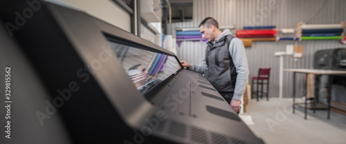 Bild auf Leinwand Technician operator checking status on touchscreen front display monitor station