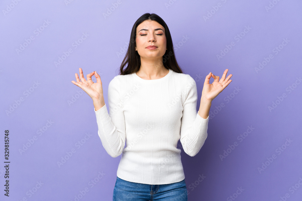 Young brunette woman over isolated purple background in zen pose Young brunette woman over isolated purple background in zen pose