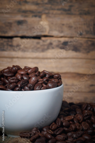 Coffee beans in a cup on a wooden table