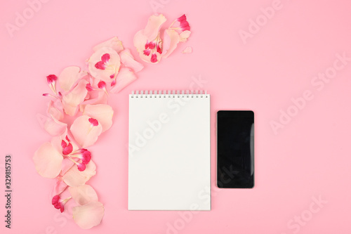 Flat lay office desk table pastel pink feminine workspace. Floral concept © SYARGEENKA