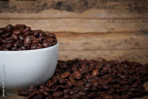 Coffee beans in a cup on a wooden table