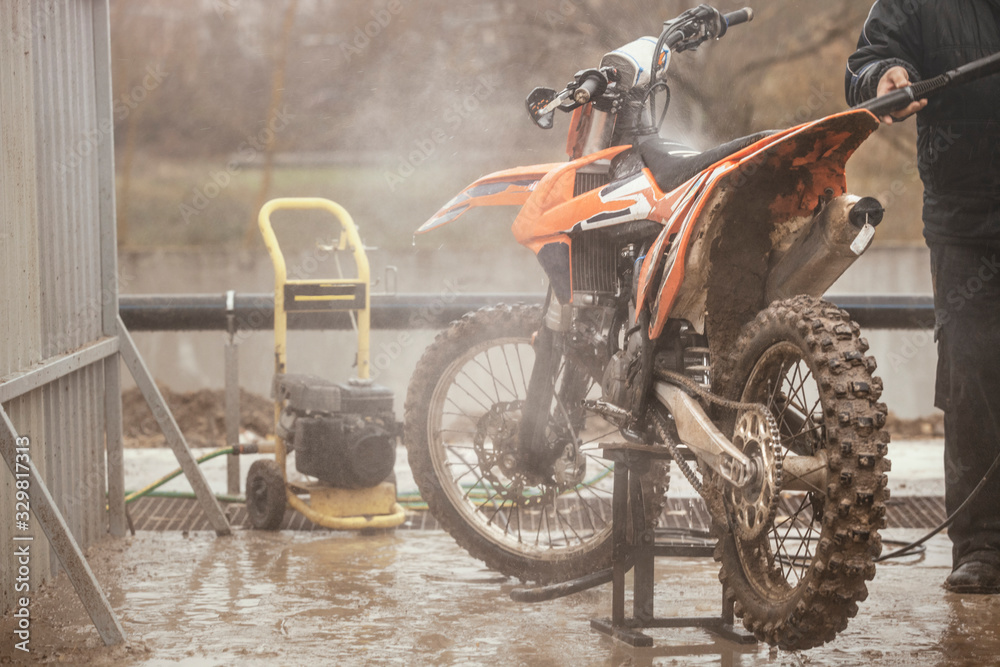 Crossbike washing after the competition. Washing dirty wheel of