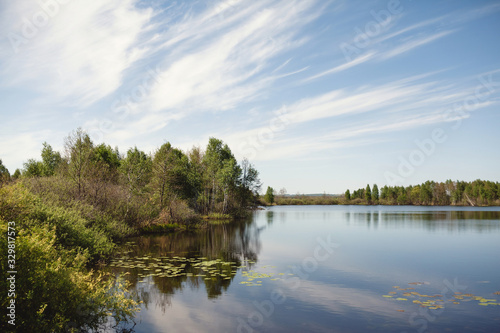 Dynamic clouds over a calm rural lake. Country Life Concept