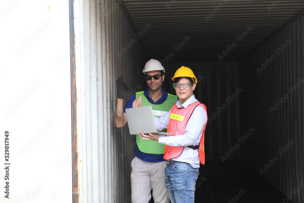 Foreman control loading Containers box from Cargo and  inspector checking Containers box with shipping containers before departure for export business logistic company