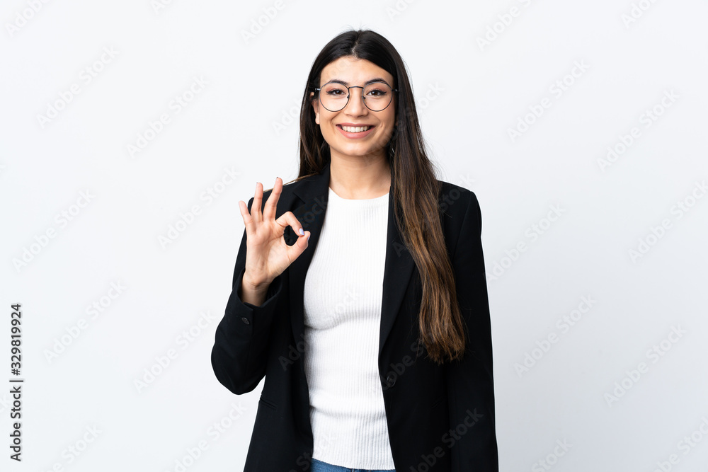 Business woman over isolated white background showing an ok sign with fingers Business woman over isolated white background showing an ok sign with fingers