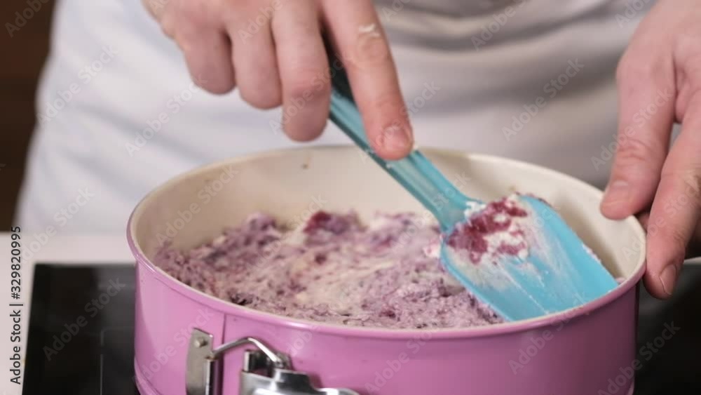 cook lines the cream pie filling with a spatula in a baking tray. Baking a pie with filling in a pastry shop. Cooking in a restaurant. cook lines the cream pie filling with a spatula in a baking tray. Baking a pie with filling in a pastry shop. Cooking in a restaurant.