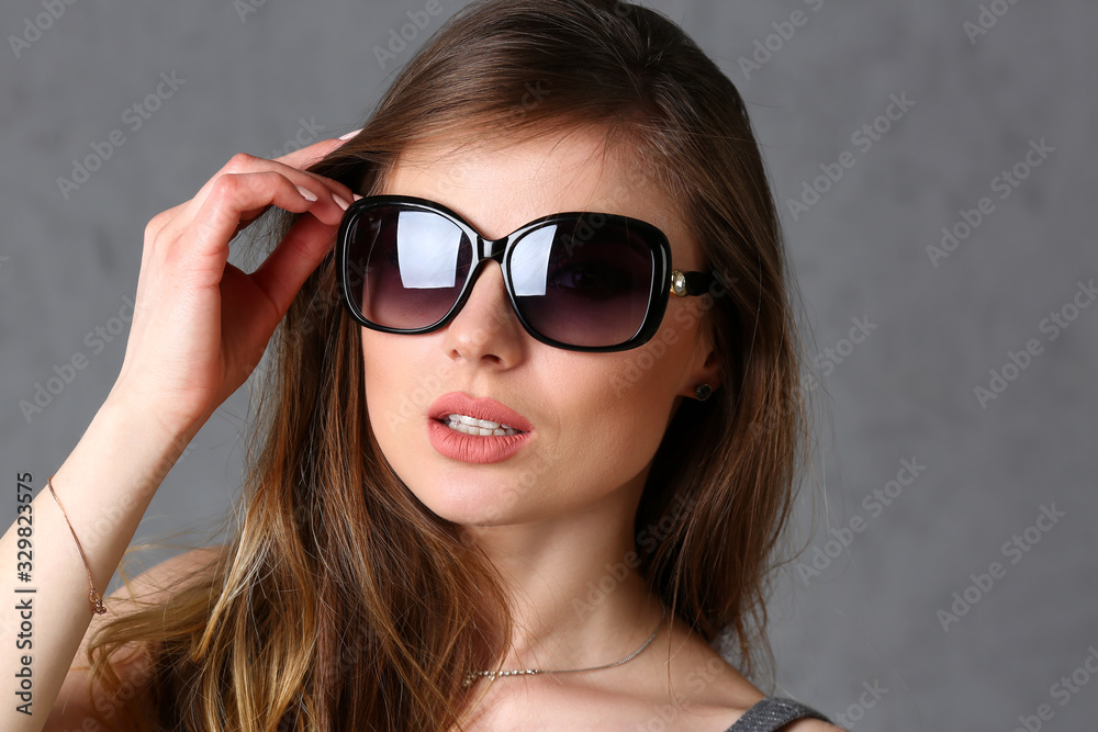 Sunglasses beauty woman portrait on gray background Sunglasses beauty woman portrait on gray background