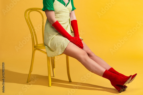 Obraz na plátne cropped view of pop art girl sitting on chair