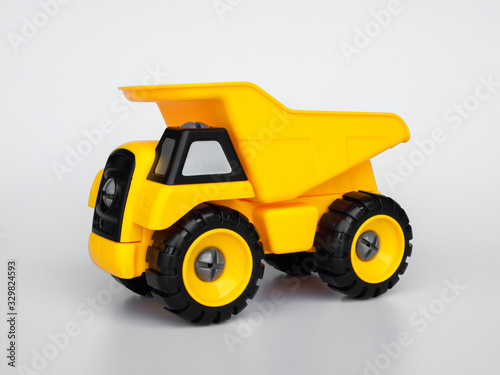 Yellow plastic truck toy isolated white background.
