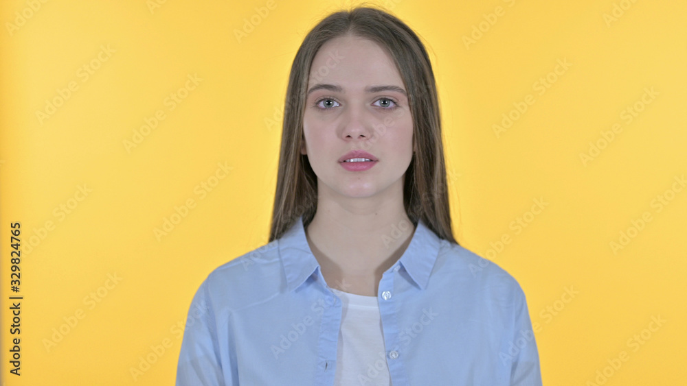 Casual Young Woman saying No by Head Shake, Yellow Background Casual Young Woman saying No by Head Shake, Yellow Background
