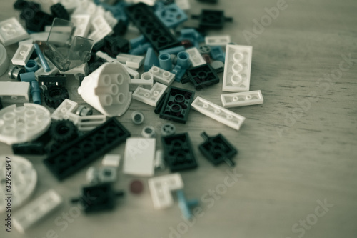 Multicolored plastic building blocks on wood table